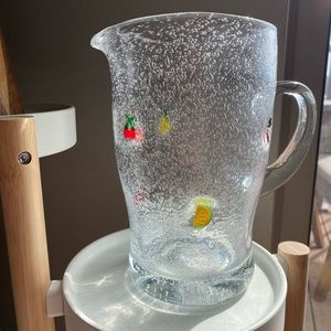Glass pitcher with fruit charms